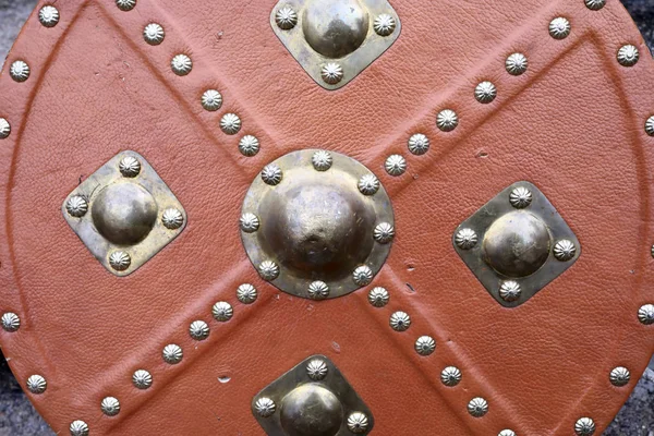 Part of shield with red leather trim