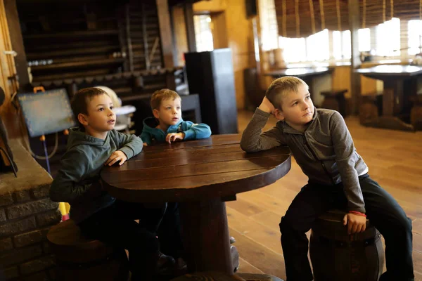 Three Boys Sitting Wooden Table Restaurant — Stock Photo, Image