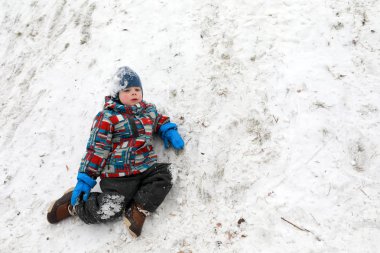 Yorgun çocuk kışın karda dinlenme