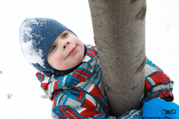 Jongen Knuffelen Boomstam Winter Park — Stockfoto