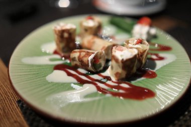 Pancakes stuffed with curd cream on plate