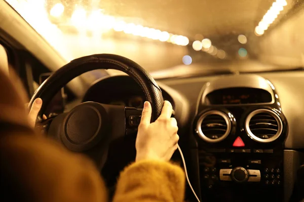 Person driving a car at night in winter