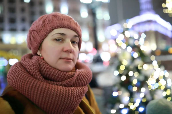 Portrait of woman in winter city at night