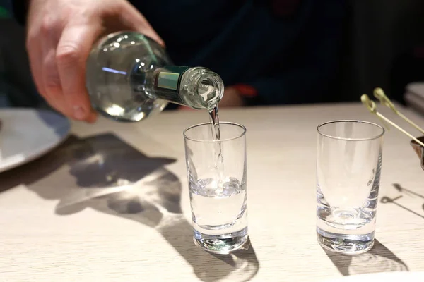 Person pouring vodka — Stock Photo, Image