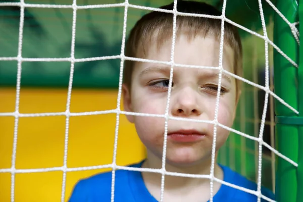 Boy behind net — Stock Photo, Image