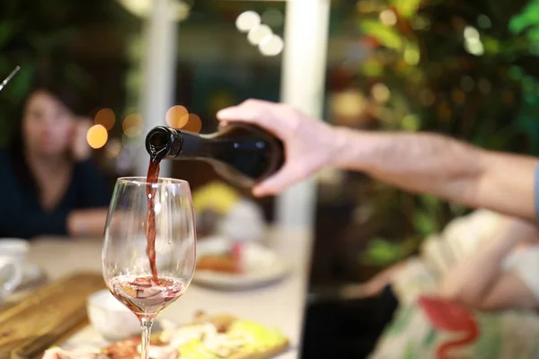 Person pouring red wine — Stock Photo, Image