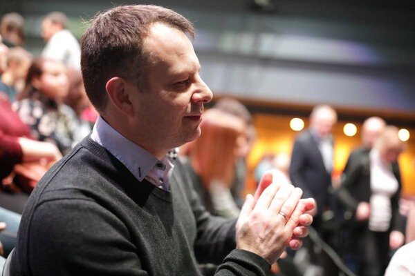 Man applauds in theater