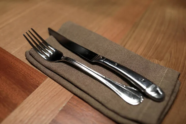 Fork and knife on brown napkin — Stock Photo, Image