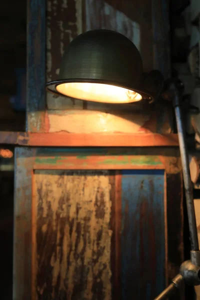 Lamp on background of wooden wall — Stock Photo, Image