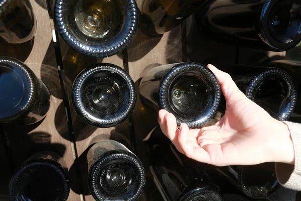 Osoba, která se dotýká prázdné láhve s vínem — Stock fotografie