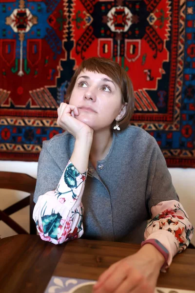 Pensive woman in restaurant — Stock Photo, Image