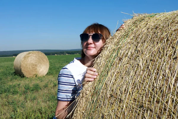 Tourist posing next to bales of straw — Stock Photo, Image