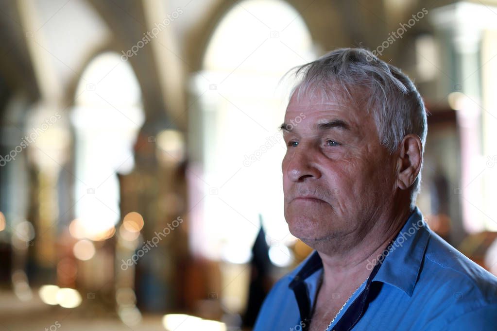 Elderly man in russian orthodox church
