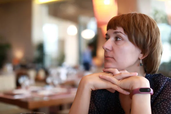 Pensive woman in restaurant — Stock Photo, Image