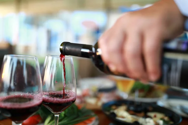 Person pouring red wine — Stock Photo, Image