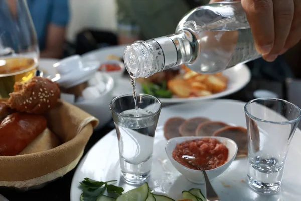Person pouring vodka — Stock Photo, Image