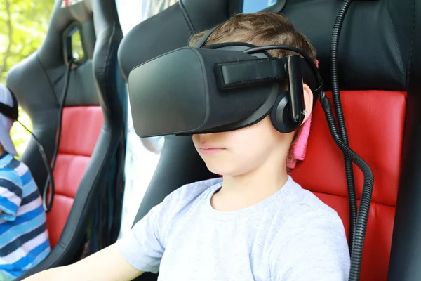 Boy playing virtual reality simulator