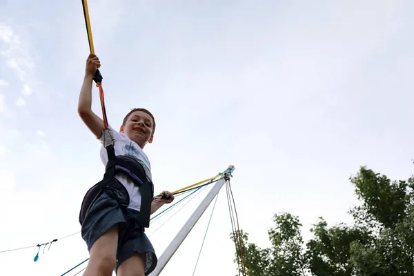 Kid jumping on bungee trampoline — Stock Photo, Image