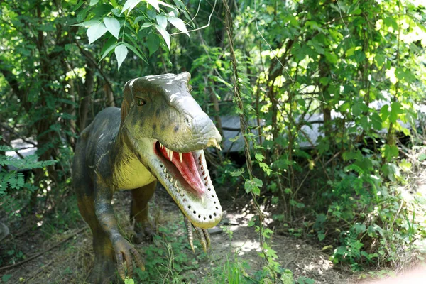 Green dinosaur in park — Stock Photo, Image