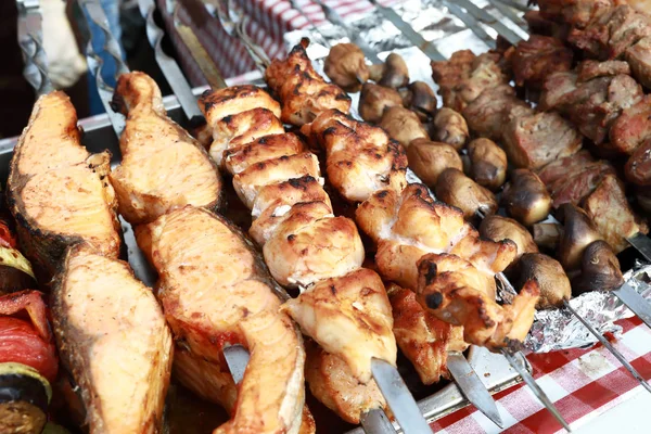 Meat and fish kebabs on skewers — Stock Photo, Image