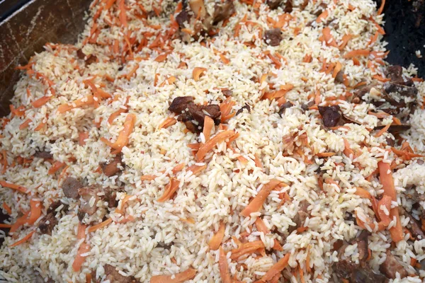 Lamb pilaf cooked in cauldron — Stock Photo, Image