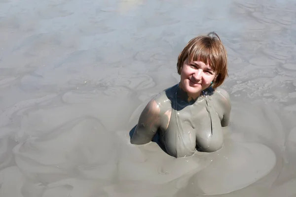 Woman in mud pool
