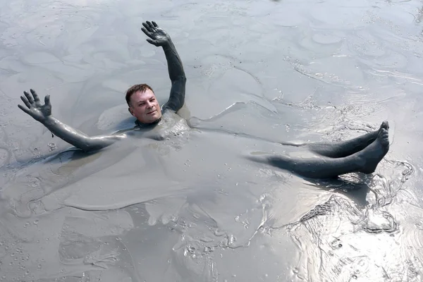 Man vilar i lera pool — Stockfoto