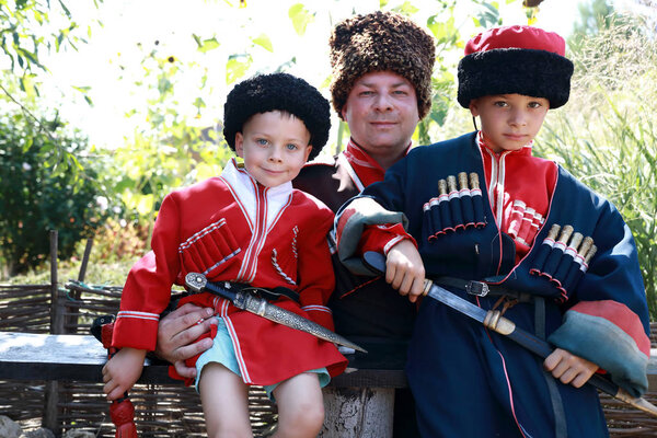 Father with sons in Cossack costumes