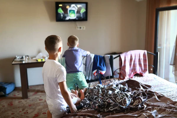 Chlapci sledují televizi v posteli — Stock fotografie