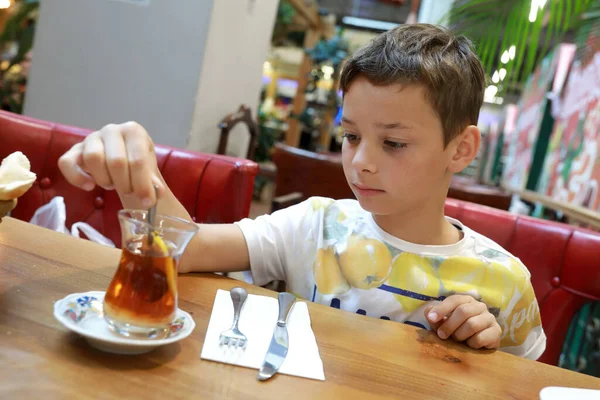 Child Stirs Sugar Cup Tea Restaurant — Stock Photo, Image