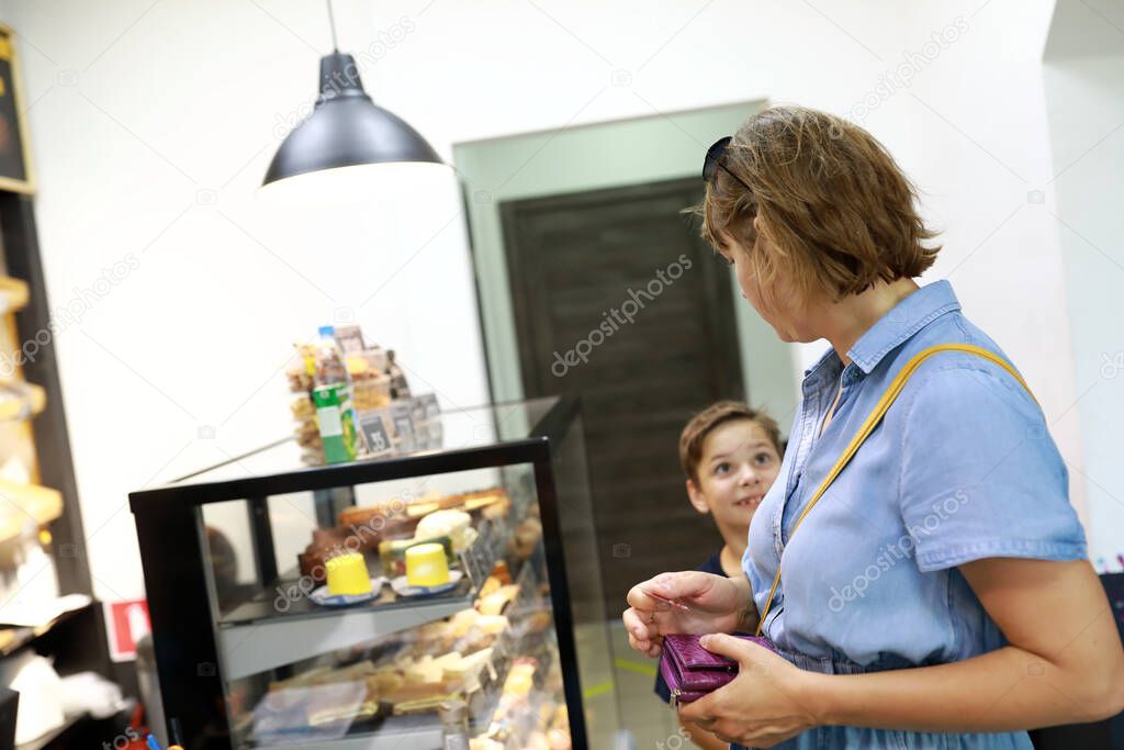 Son asks mother to buy cake in bakery