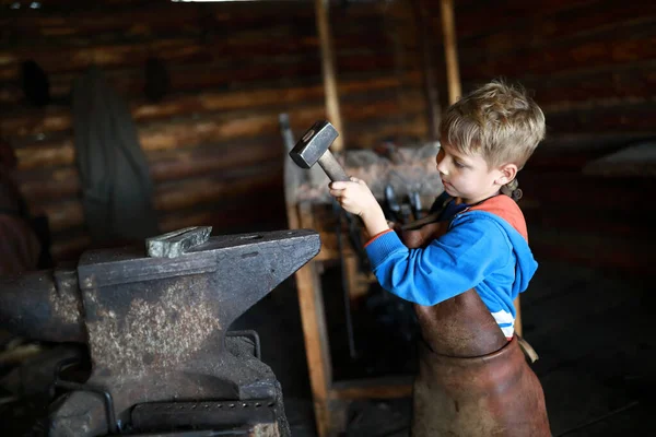 Child Hits Anvil Hammer Forge Stock Photo