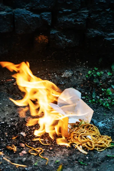 hot asian noodles with fire, close up