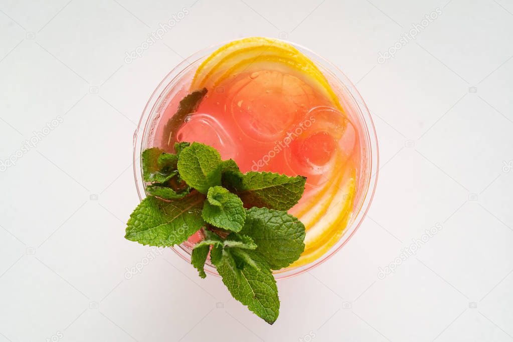 glass of lemonade with mint and fruits isolated on a white background