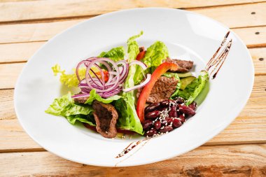 sığır etli salata, fasulye ve sebze, ahşap arka plan