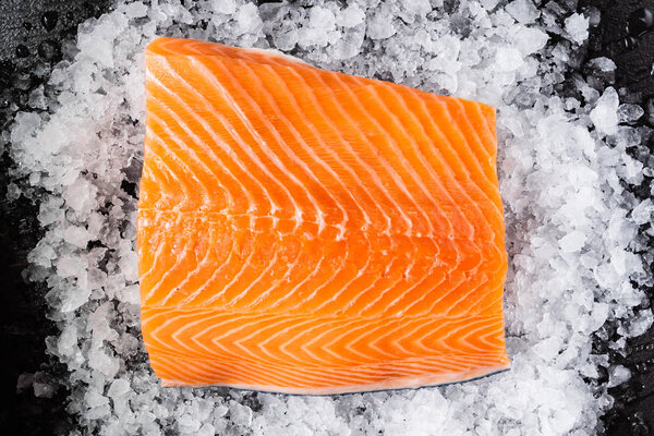Raw salmon filet on the ice