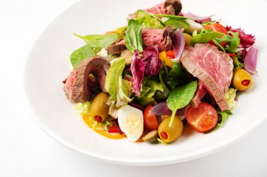 Beyaz plaka üzerinde Tay ızgara sığır salatası