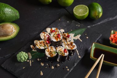 Siyah arkaplanda suşi var.