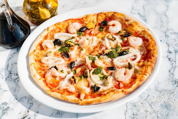 seafood pizza on the marble table, close up