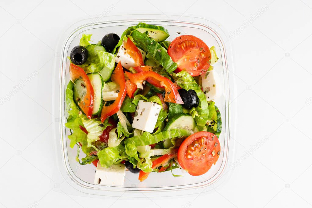 greek salad in the plastic box, close up