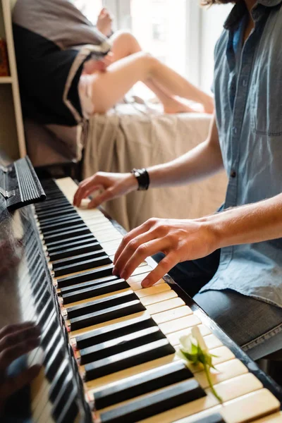 Man playing piano in the room at home