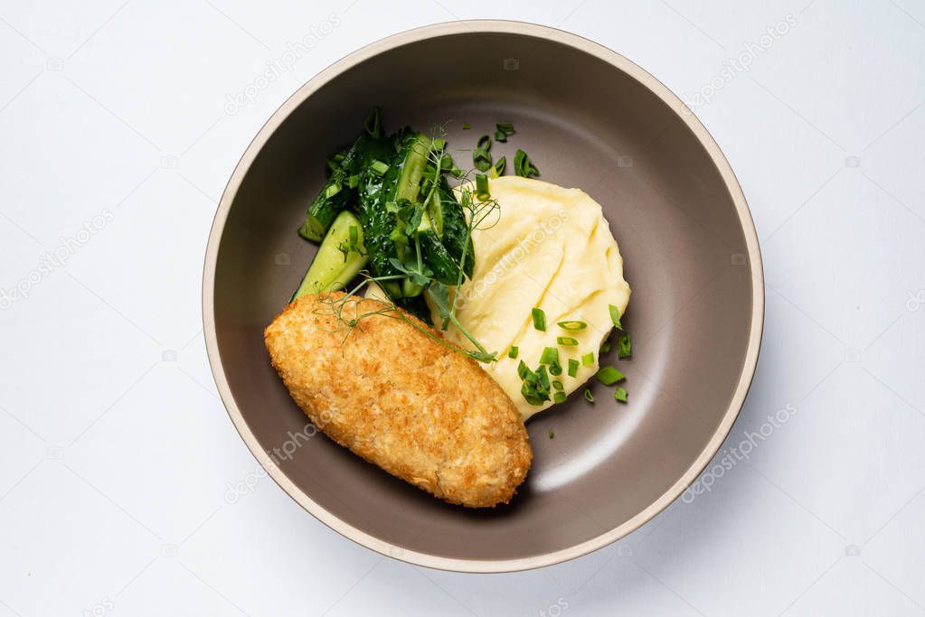 cutlet with mashed potato and salad, close up