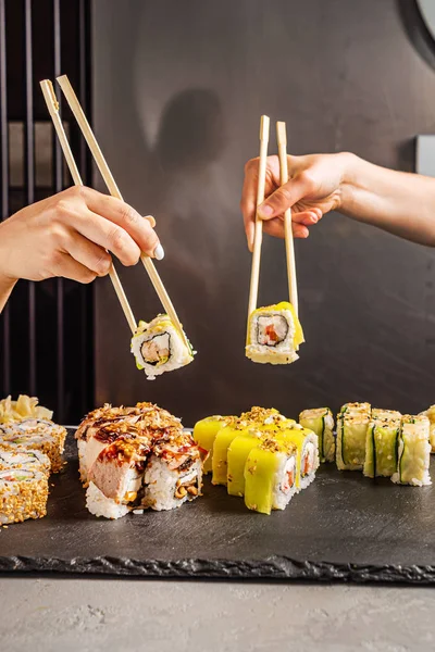 women eating sushi in the restaurant