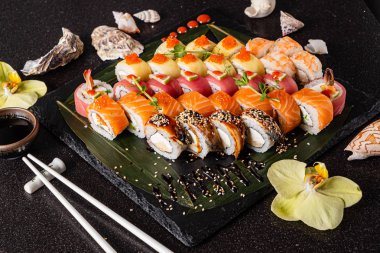 Siyah arkaplanda suşi var.