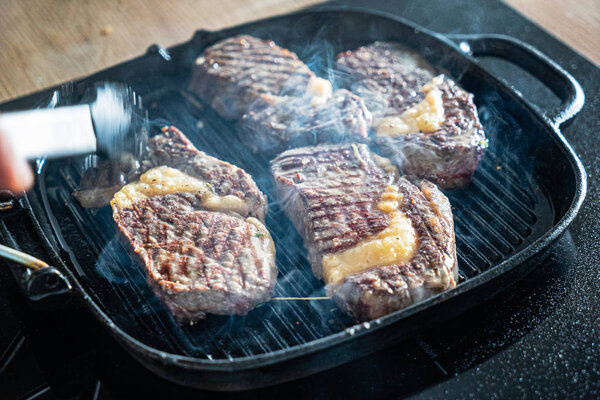 grilled steaks on the pan, close up