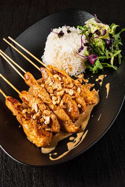 chicken kebabs with rice and salad