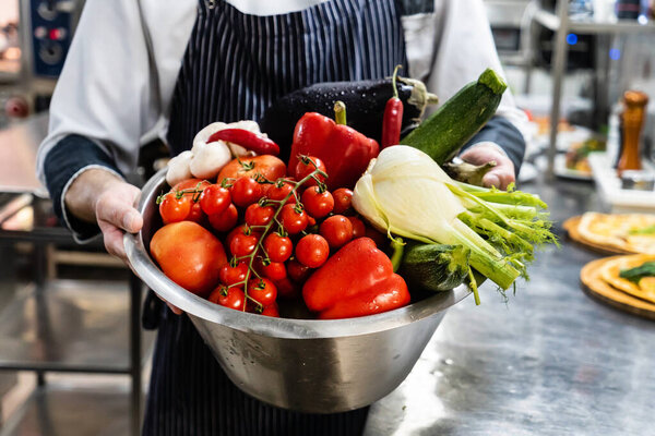 chef with fresh organic vegetables