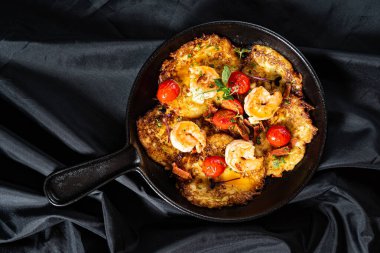 roasted vegetables with meat on frying pan 