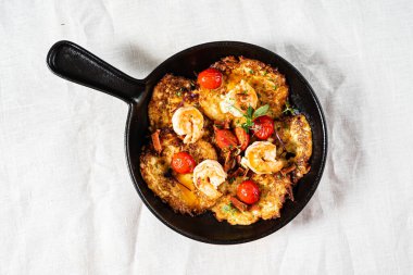 roasted vegetables with meat on frying pan 