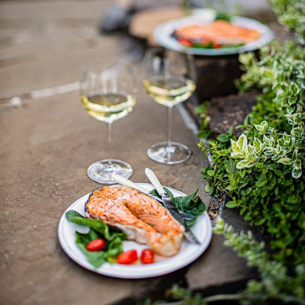 grilled salmon with salad and wine